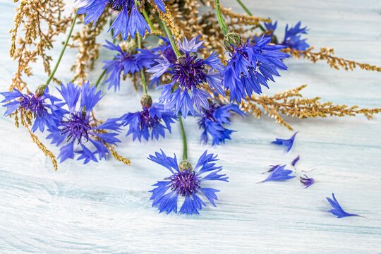 bouquet of field flowers  , Bright blue flowers made of cornflower on a wooden background