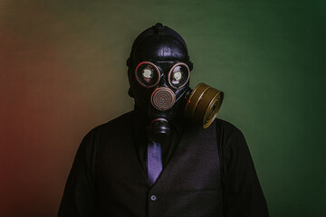 cosplay of a guy in a gas mask on a green background with glowing eyes