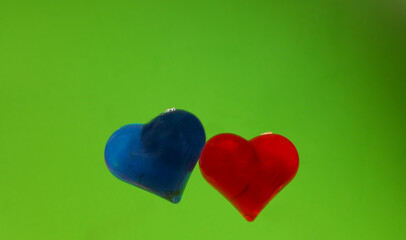 red and blue heart shapes on a green background. romantic background
