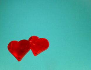 two red heart shapes on a blue background. romantic card for valentine's day, wedding