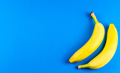 macro photo of yellow bananas over blue background