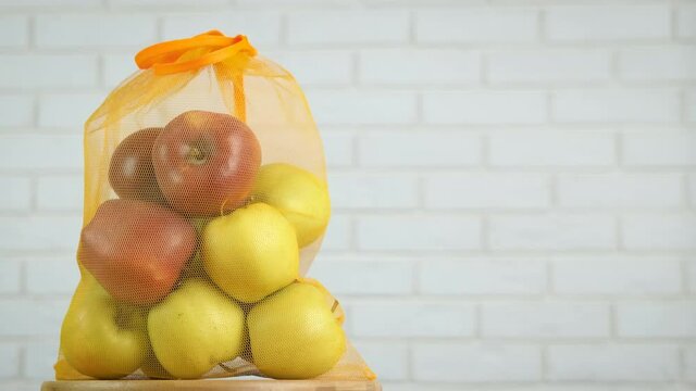 Natural apples in a string bag. Apples in a reusable bag.