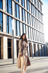 Fototapeta premium young pretty brunette woman in fashion suit at business building posing cheerful, lifestyle people concept