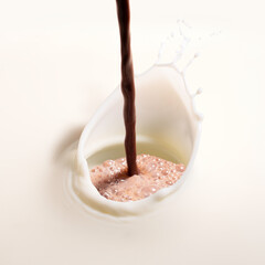 closeup of hot chocolate pouring on pure white milk splash