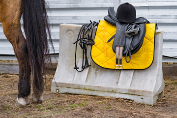 Chair to mount horse, protective helmet and other equitation. Preparing horse of the competition riders
