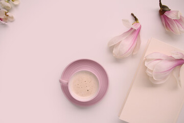 beautiful tender still life, card on a beige background, magnolia buds, a cup of cappuccino, concept of a floral spring background
