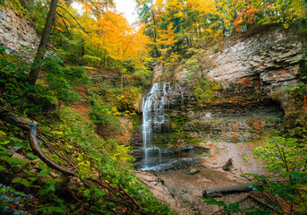 Water cascades over Tiffany Falls in autumn