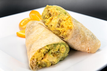Jack cheese burrito with roasted green chilli, cut in half and stacked on a plate to eat