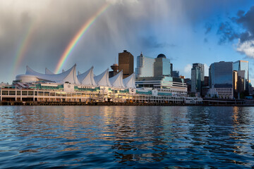 Canada Place and commercial buildings in Downtown Vancouver Viewed from water. Modern Architecture in Urban City on West Coast of British Columbia, Canada. Sunset Sky Art Render with Rainbow