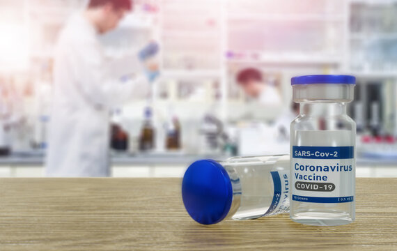 COVID-19 vaccine. Corona virus Vaccine concept with Laboratory doctor background. Vaccine Concept of fight against coronavirus. Bottle with vaccine for coronavirus cure. 3D rendering.