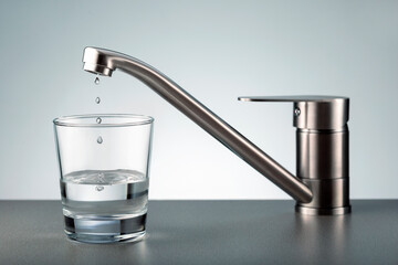 Faucet and water drops in glass. Save water.