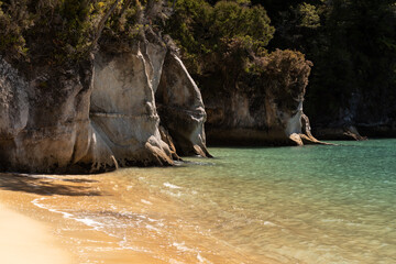 Granite rocks and cliffs at the end of the sandy beach at Anchorage Bay, Able Tasman National Park,...