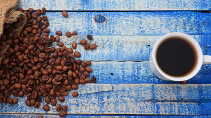 Roasted coffee beans and a glass of hot coffee