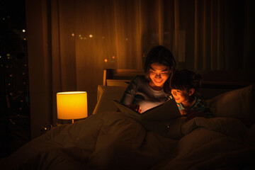 mom and daughter have goodtime reading bedtime stories for daughter
