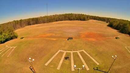 Drone view of trap field, stands, and trap house.  