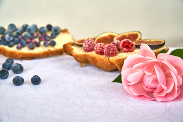 Obraz na płótnie Canvas Croissant toast with butter and figs. French dip sandwich with berries raspberries for Breakfast. High quality photo