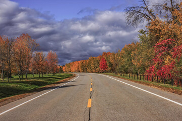 Sir John A Macdonald Parkway Ottawa looking down centreline of empty curving road with fall foliage...