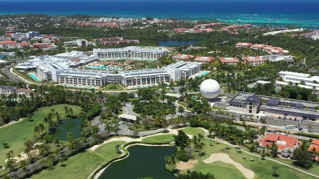 Golf course with roads, coconut palm trees and houses. Aerial view. Dominican Republic