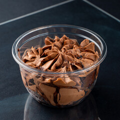 Fluffy chocolate pudding in a plastic take away cup