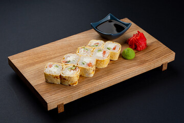 Crepe sushi rolls with salted salmon and red caviar, cuisine mix