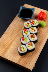 Vegetarian sushi rolls with tomato, lettuce and avocado, studio, menu photo