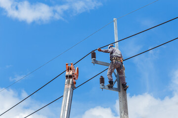 Electricians Wiring Cable repair services,worker in crane truck bucket fixes high voltage power...