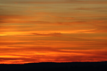 Fototapeta na wymiar Winter sunset with hues of yellow, orange and red