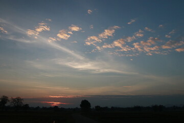 The orange light from sunrise ,silhouette and clouds sky in the morning