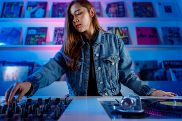 Joven mujer dj latina, mezclando música en una tienda de discos de vinilo. Concepto de música...