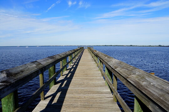 The view of a wooden pier by the blue ocean Punta Gorda, Florida, U.S