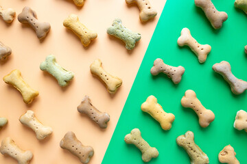 Small colored Dog Bones pattern on green yellow wallpaper background.