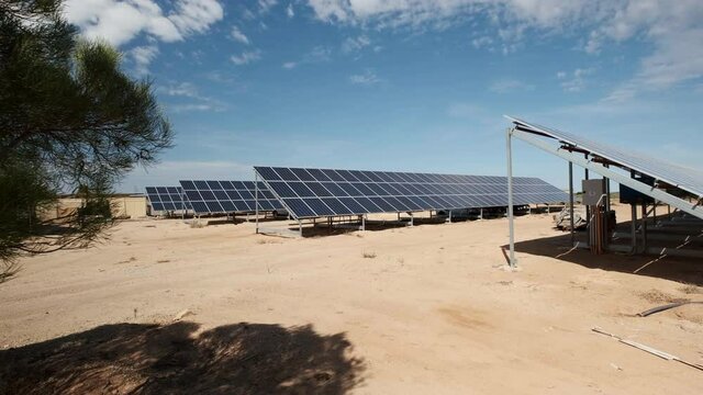 Solar panels in a desert field in an arid landscape. Green energy concept