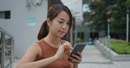 Woman use of mobile phone in city
