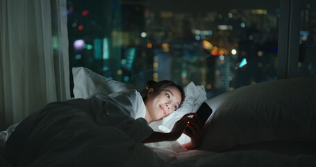 Woman use of mobile phone and read on cellphone at night