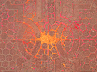 colorful orange holi powder on floor tiles at city palace in jaipur