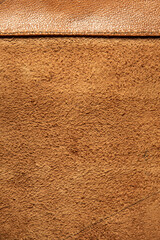 leather grunge background: an old piece of tough camel skin, with scuffs, spots, scars, stitched...