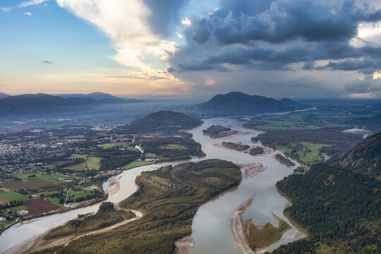 Aerial landscape picture of Fraser River and farms. Taken near Chilliwack city, East of Vancouver, British Columbia, Canada. Sunrise Sky Art Render