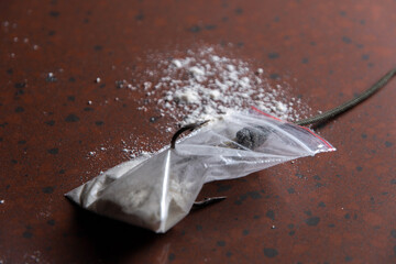 drug trap concept: drug bag with triple hook inside