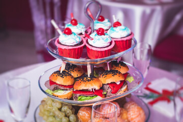 Beautifully decorated catering banquet table with variety of snacks and appetizers in new year christmas setting and on christmas new year celebration