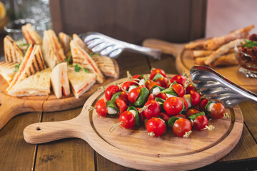 Beautifully decorated catering banquet table with different food snacks and appetizers on corporate christmas birthday party event or wedding celebration