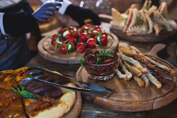 Beautifully decorated catering banquet table with different food snacks and appetizers on corporate christmas birthday party event or wedding celebration