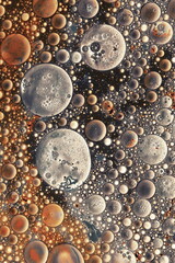 Acrylic oil bubbles abstract background gold brown colors .Wallpaper pattern. Fluid art texture. 