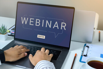 Person using a laptop computer for online training webinars. E-learning browsing connection and cloud online technology webcast concept. Laptop mockup with clipping path on screen.