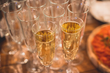 View of alcohol setting on catering banquet table, row line of different colored alcohol cocktails on a party, martini, vodka, spritz and others on decorated catering table event