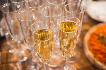 View of alcohol setting on catering banquet table, row line of different colored alcohol cocktails on a party, martini, vodka, spritz and others on decorated catering table event