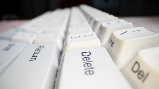 White keyboard keys. Camera movement from left to right. Macro photography.
