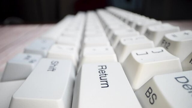 White keyboard keys. Camera movement from left to right. Macro photography.