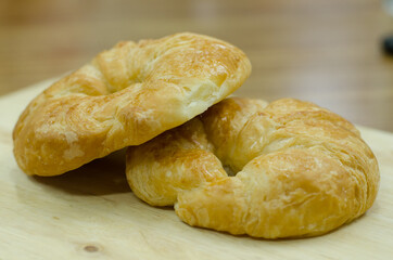 croissants with bite marks on wood and blur