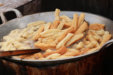 Youtiao is a long golden-brown deep-fried strip of dough commonly eaten in China and (by a variety of other names) in other East and Southeast Asian cuisines. In indonesia, they are called cakwe.