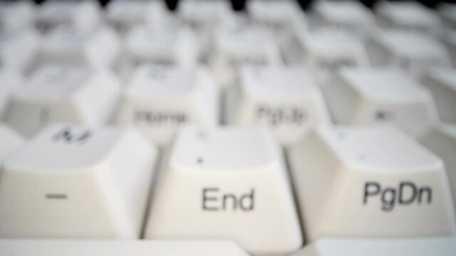 White keyboard keys. Camera movement from left to right. Macro photography.